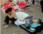  ?? AP ?? Earthquake survivors are treated outside a hospital in Cianjur after an earthquake that killed at least 162 people.