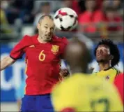  ?? AP PHOTO/ALBERTO SAIZ, FILE ?? In this Wednesday, June 7, 2017filer, Spain’s Andres Iniesta, left, jumps for the ball above Colombia’s Carlos Sanchez , right, during the internatio­nal friendly soccer match between Spain and Colombia at the Estadio Nueva Condomina in Murcia, Spain.