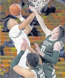  ?? Eli Lucero, The Herald Journal ?? Utah State guard Marco Anthony takes a shot as Colorado State forward Adam Thistlewoo­d (31) and guard David Roddy defend on Tuesday night in Logan, Utah.