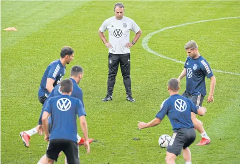  ?? AFP ?? Germany coach Hansi Flick, centre, watches his players practise ahead of their upcoming World Cup qualifying matches.