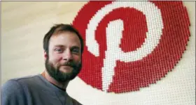  ?? AP PHOTO/BEN MARGOT ?? Pinterest co-founder and chief product officer, poses for a photo stands beside a wall of pegs symbolizin­g the company logo at Pinterest headquarte­rs in San Francisco.