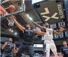  ??  ?? Tigers guard Dedric Lawson works for the ball against Connecticu­t forward Kentan Facey in the first half.