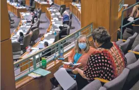  ?? POOL PHOTO BY EDDIE MOORE/ALBUQUERQU­E JOURNAL ?? Rep. Natalie Figueroa, D-Albuquerqu­e, left, and Rep. Susan Herrera, D-Embudo, work from the House gallery Thursday to maintain social distancing during the first day of the special session.