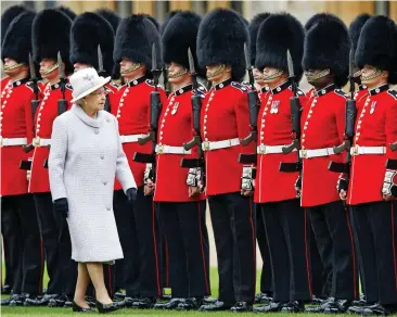  ?? ?? Royal protection: Coldstream Guards at the entrance to Windsor Castle... the historic regiment is based in the town to protect the Queen and the Royal Family