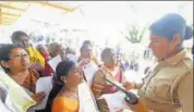  ??  ?? An official checks the age proof of women devotees at the Pamba base camp of Sabarimala Temple in Kerala in Nov, 2019. PTI