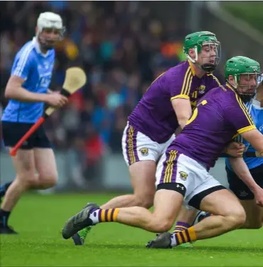  ??  ?? Wexford joint captain Matthew O’Hanlon contesting possession with Dublin’s Liam Rushe as Aidan Nolan awaits the outcome.