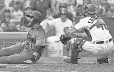  ?? PHOTOS BY NAM Y. HUH/AP ?? The D-Backs' J.D. Martinez, left, scores past Cubs catcher Willson Contreras during the eighth inning on Thursday in Chicago.