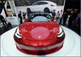  ?? LONG WEI / FOR CHINA DAILY ?? Tesla Inc’s Model 3 on display at an auto expo held in Beijing in April.