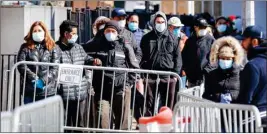  ?? PTI ?? Patients wearing face masks and personal protective equipment wait on line for COVID-19 testing outside Elmhurst Hospital Center, Friday