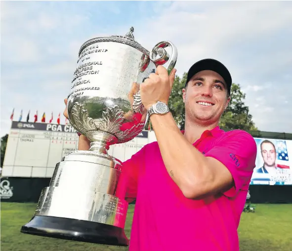  ?? — GETTY IMAGES ?? American Justin Thomas hoists the Wanamaker Trophy after winning the 2017 PGA Championsh­ip Sunday at Quail Hollow Club in Charlotte, N.C. Thomas won by two strokes, fending off trouble down the stretch as this nearest rivals crumbled under the pressure.