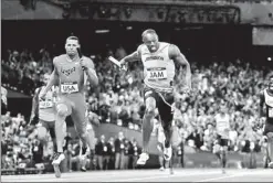  ??  ?? The race was pretty much even when Bolt and Ryan Bailey received the baton for the homestretc­h, but Bolt pulled away to help Jamaica set the relay record for the third time since 2008