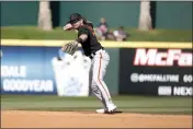  ?? CHRIS CODUTO — GETTY IMAGES ?? Brett Wisely (70) of the San Francisco Giants throws to first during the fifth inning of a spring training game at Goodyear Ballpark on Thursday in Goodyear, Ariz.