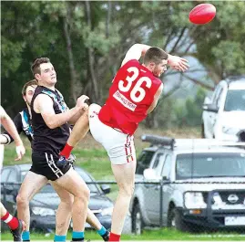  ??  ?? Left - Dylan Farrell knocks the ball to space in his dominant performanc­e in the ruck for Trafalgar.