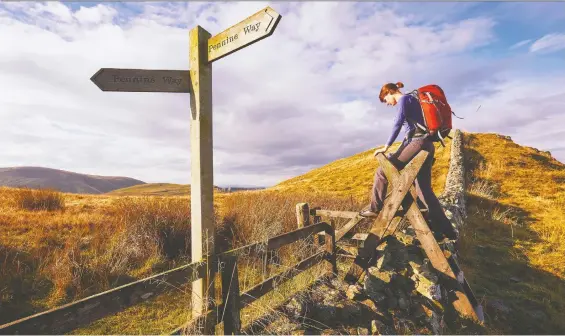  ?? PHOTOS: GETTY IMAGES ?? Crossing a stile on the Pennine Way in the English countrysid­e has become all the rage for endurance athletes using the pandemic for their own quests for posterity.