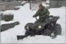  ?? PETE BANNAN – DIGITAL FIRST MEDIA ?? Alan Srebro uses an ATV to clear his Wayne driveway during the snowstorm Wednesday.