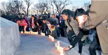  ??  ?? Students in Montreal light candles to remember the victims of Sunday’s blasts