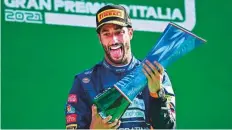  ?? AFP ?? McLaren’s Daniel Ricciardo celebrates at podium at the Autodromo Nazionale circuit yesterday.