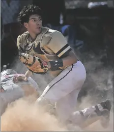  ?? ?? YUMA CATHOLIC CATCHER ALAN CUEN checks what’s happening behind him after tagging out Buckeye-Odyssey Institute’s Ismael Hinojosa at the plate in the top of the first inning of Tuesday afternoon’s state tournament first-round game.