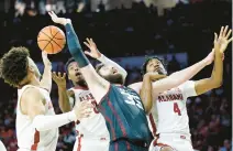  ?? GARETT FISBECK/AP ?? Oklahoma forward Tanner Groves (35) fights for the ball with Alabama guard Mark Sears, left, guard Jaden Bradley (0) and forward Noah Gurley (4) during the second half of the Sooners’ victory Saturday in Norman, Oklahoma.