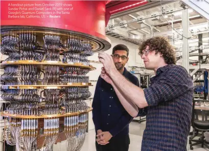  ?? — Reuters ?? A handout picture from October 2019 shows Sundar Pichai and Daniel Sank (R) with one of Google’s Quantum Computers in the Santa Barbara lab, California, US.