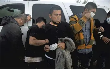  ?? Gary Coronado Los Angeles Times ?? MEN FROM HONDURAS and Mexico are detained by the U.S. Border Patrol last week near McAllen, Texas. While in Guatemala, Vice President Kamala Harris warned would-be migrants they’d be turned away.