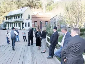  ??  ?? Walhalla Heritage and Advancemen­t League vice-president Brian Brewer, in the centre of the bridge, explains to Baw Baw Shire councillor­s and staff the stories behind some of the historic buildings and other features of the town during a tour ahead of last week’s council meeting.