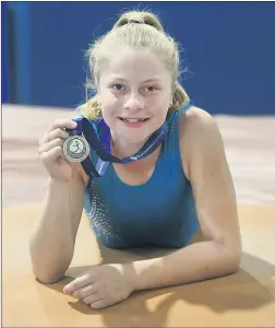  ??  ?? PODIUM FINISH: Natimuk and District Gymnastic Club’s Kayla Kelm with the silver medal she won on vault at the Women’s Artistic Gymnastics Senior Victorian Championsh­ips at the weekend. Picture: PAUL CARRACHER