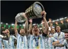  ?? ?? Lionel Messi lifts the Copa América trophy as he celebrates with team-mates after Argentina’s victory over Brazil. Photograph: Carl de Souza/AFP/Getty Images