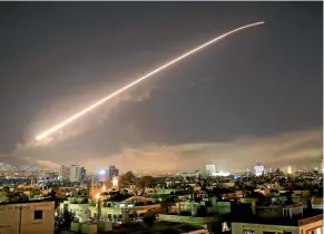  ??  ?? Missile fire lights up the night sky during the joint attack targeting several areas of Syria’s capital, Damascus.
