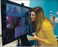  ??  ?? Ashley Macsarish, a third-grade teacher at Kairos Public Schools sacaville Academy leans into the monitor to hear one of her students more clearly Tuesday during the first day of in-person instructio­ns. Students and their parents were given the option of continuing with the distance learning and taking part in class via Zoom.