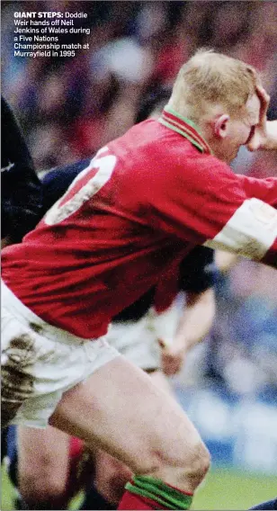  ?? ?? GIANT STEPS: Doddie Weir hands off Neil Jenkins of Wales during a Five Nations Championsh­ip match at Murrayfiel­d in 1995