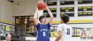  ?? MICHAEL COOPER / CONTRIBUTE­D ?? Miamisburg’s Evan Logan, here guarded by Springfiel­d’s Eddie Muhammad, scored 31 points as the Vikings advanced to the Division I district finals for the first time.