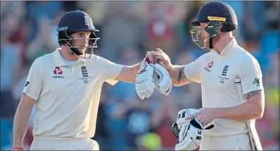  ??  ?? Joe Root and Ben Stokes give each other knuckles at the close of play yesterday