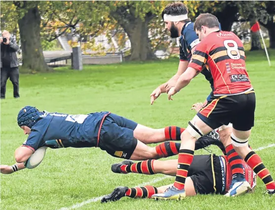  ?? Jon Mussen. ?? James Forrester dives over the line to bag another try for Dundee High in their 62-6 rout of Stewart’s Melville at Mayfield.