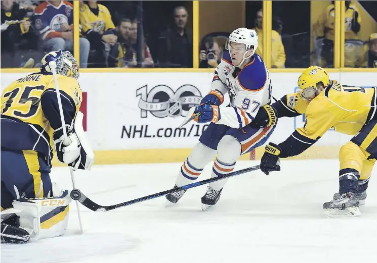  ?? THE ASSOCIATED PRESS ?? Oilers centre Connor McDavid finishes off a dazzling rush during the first period of Sunday’s game in Nashville by firing the puck past Predators goalie Pekka Rinne.