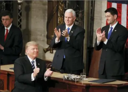  ?? AP PHOTO/ALEX BRANDON ?? President Donald Trump, Vice President Mike Pence and House Speaker Paul Ryan of Wis. applaud on Capitol Hill in Washington, Tuesday, Feb. 28, 2017, following the president’s address to a joint session of Congress.