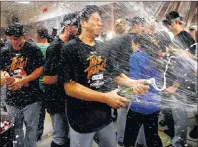  ?? AP PHOTO ?? Los Angeles Dodgers pitcher Kenta Maeda celebrates in the clubhouse after Game 3 of the National League Division Series against the Arizona Diamondbac­ks on Monday.