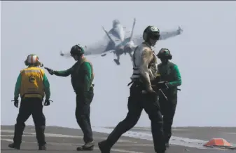  ?? Bullit Marquez / Associated Press ?? A U.S. Navy F18 fighter jet takes off Friday from the aircraft carrier Carl Vinson. The ship is patrolling the disputed South China Sea, which China claims virtually in its entirety.