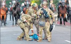  ?? AFP ?? ■
Military police officers restrain a protester near the White House in Washington, DC.