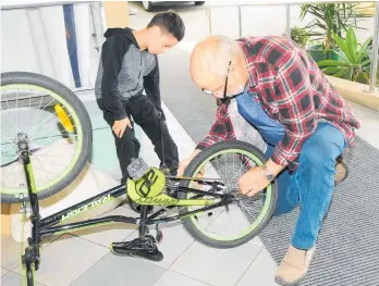  ?? ?? Volunteer Terry fixes a child’s bike at Levin’s Repair Cafe.