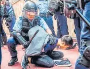  ?? AFP ?? Police detain a man after fights broke out at a shopping mall between pro-China supporters and anti-govt protesters in Hong Kong.