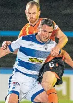  ??  ?? Mark Reynolds challenges veteran Morton striker John Sutton.