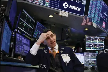  ?? RICHARD DREW — THE ASSOCIATED PRESS FILE ?? Specialist Peter Mazza works at his post on the floor of the New York Stock Exchange.