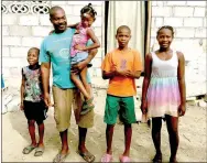  ?? COURTESY PHOTO ?? A mission team from Prairie Grove Christian Church installed a toilet for this family in Haiti and also built a door for their house. Pajotte, his wife and four children live in the concrete house in the background.