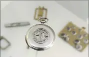  ??  ?? A platinum and diamond Patek Philippe pocket watch with the initials AC, that once belonged to Al Capone.