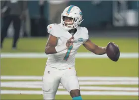  ?? LYNNE SLADKY - THE ASSOCIATED PRESS ?? Miami Dolphins quarterbac­k Tua Tagovailoa (1) looks to pass during the second half of an NFL football game against the New York Jets, Sunday, Oct. 18, 2020, in Miami Gardens, Fla.