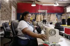  ?? ?? A seamstress assembles a hat in Tshepo Jeans workshop in Johannesbu­rg.