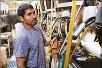  ?? Associated Press ?? Farmworker Dago Carrera, of Mexico, works at the Dutch Hollow Farms, milking Jersey dairy cows on Sept. 20 in Schodack Landing, N.Y. Harvest season means long days for U.S. farmworker­s — but usually no overtime pay. New York is now joining several states that have begun to change this rule.