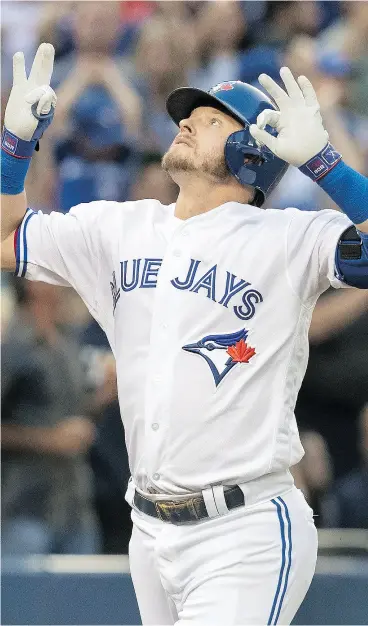  ?? FRED THORNHILL / THE CANADIAN PRESS ?? Josh Donaldson celebrates his two-run home run against the New York Yankees in the third inning of Toronto’s Tuesday night win at the Rogers Centre.