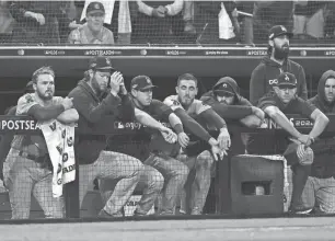  ?? HARRY HOW/GETTY IMAGES ?? The Dodgers dugout reacts during the ninth inning against the Padres in Game 4 of the National League Division Series.